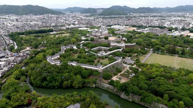 Aerial Flyaround of Himeji Castle with Moat and Historic Fortifications in Hyogo Japan