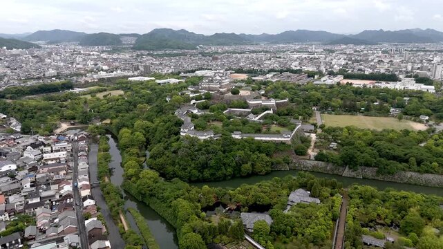 Aerial Approach to Himeji Castle and Historic Moat Surrounded by Urban Landscape in Hyogo Japan