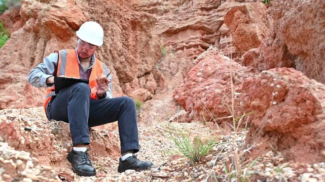 A specialist geologist is examining the soil for research into the past of this area.