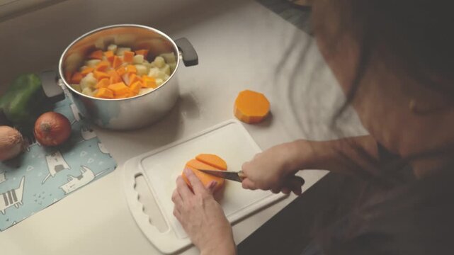 Chef cutting butternut squash preparing vegetable soup