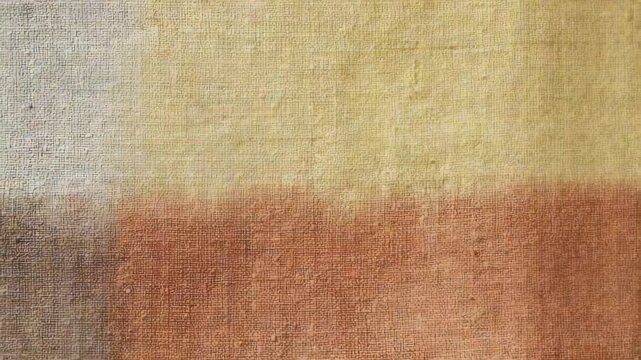 Closeup of a painted canvas featuring a geometric pattern of earthy tones and subtle texture. This abstract background is perfect for contemporary art, digital design, and stylish visual content