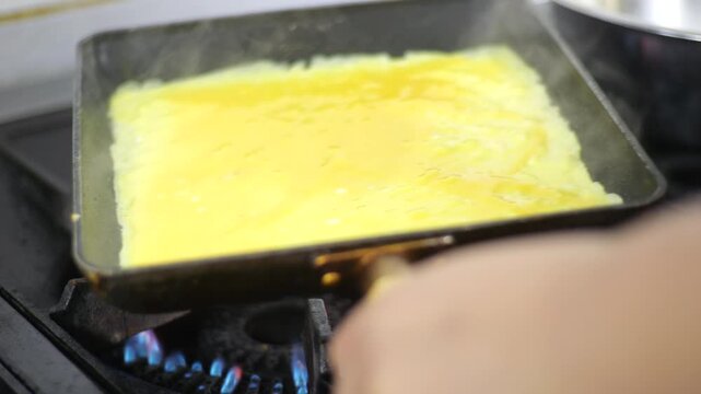 Korean traditional side dish rolled omelet Gyeranmari K-food egg cooking process 대한민국 한국 한식 계란말이 달걀말이 부침 계란 달걀 요리 조리 과정 사각팬 프라이팬 계란물 뒤집기 기술 주방 식당 맛집 비법 전통의 맛 고소한 풍미 깊은 향 감칠맛 부드러운 식감 겹겹이 쌓인 모양 반찬 미식 식문