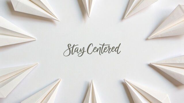Stay Centered Motivational Quote with White Paper Airplanes Arranged in a Circular Pattern on a Light Background