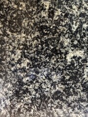 Fototapeta premium Abstract natural dark stone background featuring grey and white crystalline structures.