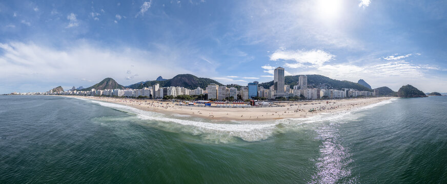 Rio de Janeiro, Brazil - 13 June 2026: Aerial view of Copacabana beach during the World Cup 2026 with crowds of people, city skyline, and lush mountains under a blue sky.