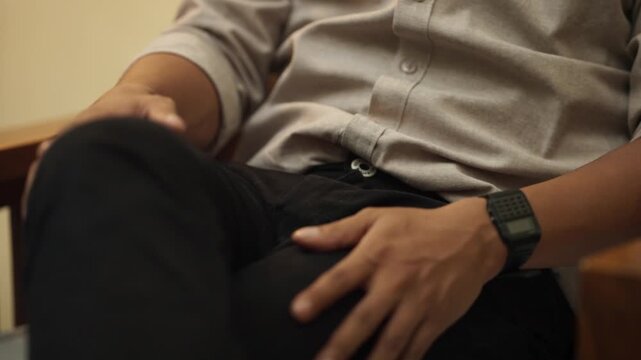 Close Up Hand Fastening Open Belt Buckle on Pants