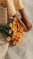 Obraz premium Close-up of bare feet beside orange flowers on textured surface