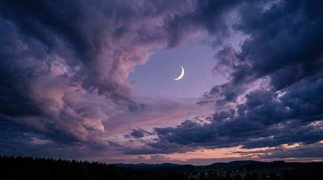 Dramatic twilight landscape with a crescent moon peeking through stormy purple and pink clouds over a silhouetted forest