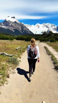 A female tourist is walking along the Laguna Torre hiking trail near El Chalten, Argentina