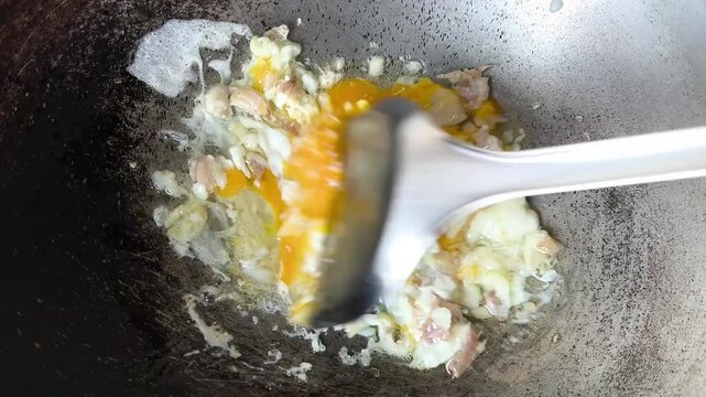 Cooking omelet in pan, indoor Chiangmai Thailand.