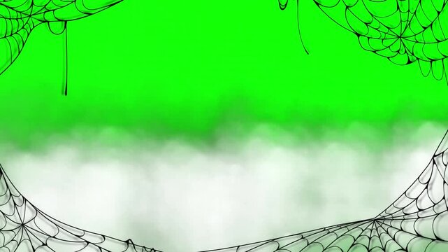 Spiderwebs frame the edges of a green screen background to provide a spooky atmosphere for video editing.
