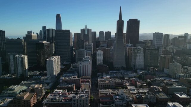 Aerial drone footage of Downtown San Francisco, California, featuring the city's iconic skyline, modern skyscrapers, bustling financial district, and urban landscape. Cinematic bird's-eye view