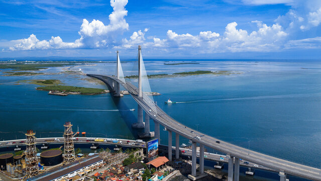 Cebu City, Philippines - 12 June 2026: Aerial view of the Cebu-Cordova Link Expressway CCLEX bridge spanning across the blue sea under a bright sky with white clouds.