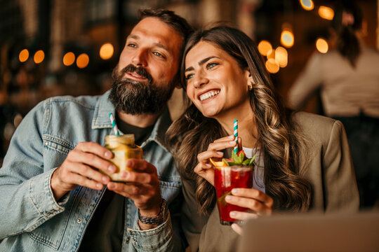 Happy couple enjoying drinks on a romantic date evening