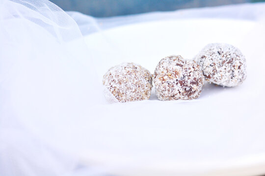 Three chocolate truffles in coconut. 