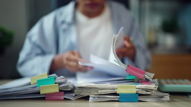 Office Employee Sorting Business Files and Paperwork