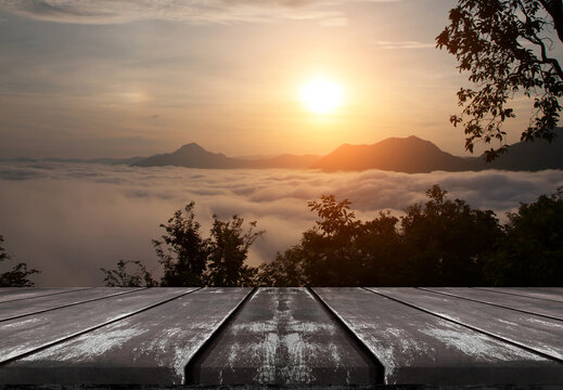 Empty old wooden table top with beautiful sea of fog and sunrise background.