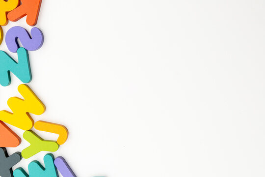 Flat Lay Studio Shot of Colorful Wooden Alphabet Left Side Border with Copyspace
