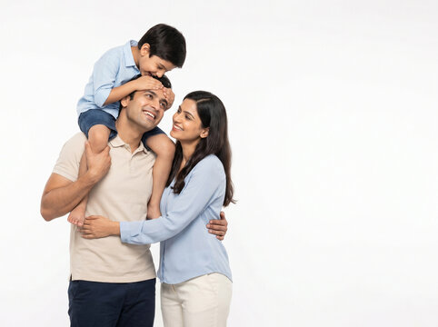 indian family sharing affectionate moment with child on fathers shoulders for family trust and emotional security concept
