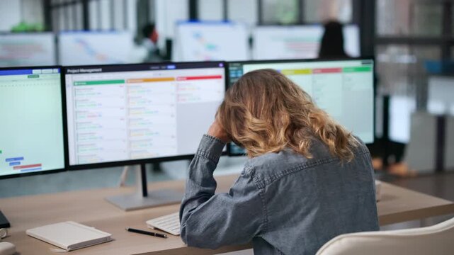Project Manager Reviews Broken Schedule On Computer, Feeling Stressed