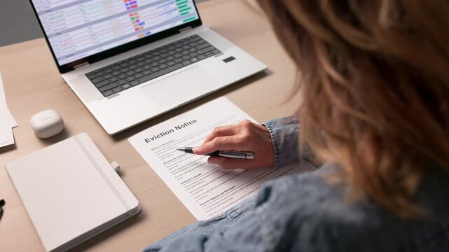 Person Reviewing Eviction Notice Document Before Court Hearing