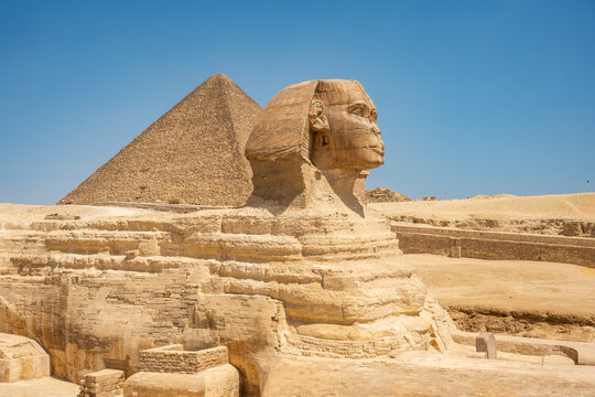 The Great Sphinx of Giza and Khufu's Great Pyramid at the background, southwest of Cairo, in Egypt.