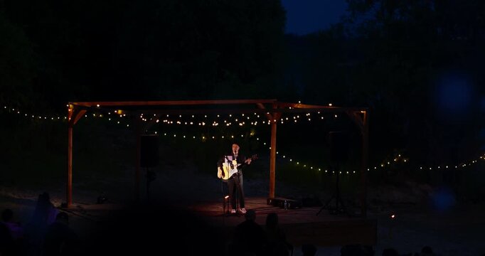 Warm golden string lights bokeh over dark nighttime scene