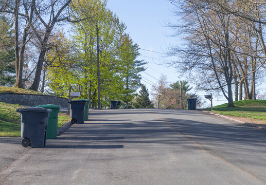 trash cans on the residential street in curbside collection day