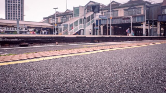 LONDON - timelapse busy train station platform with negative space in foreground