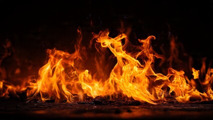 Fototapeta premium Vibrant Orange and Yellow Flames Burning Intensely on Black Background
