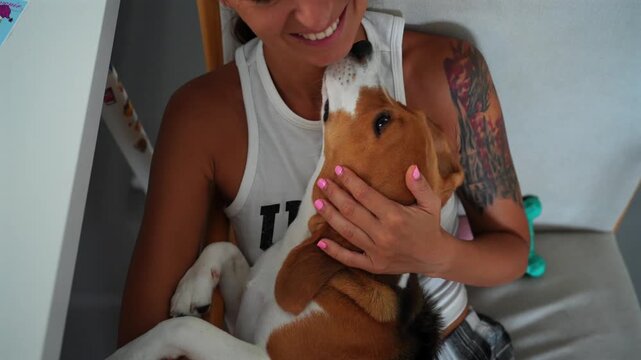 young woman playing dog beagle