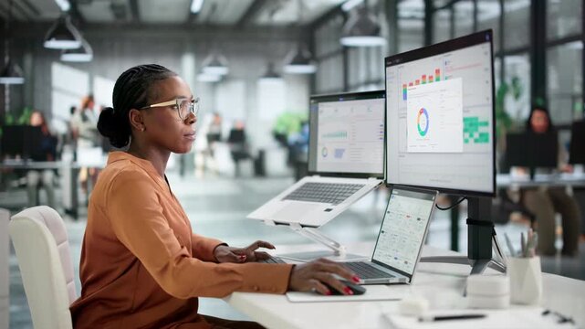 Financial Analyst Reviews Detailed Expense Reports On Laptop