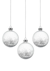 Obraz premium Three perfectly spherical transparent glass baubles filled with highly reflective silver glitter, isolated against a high-key transparent background. Minimalist holiday elegance concept