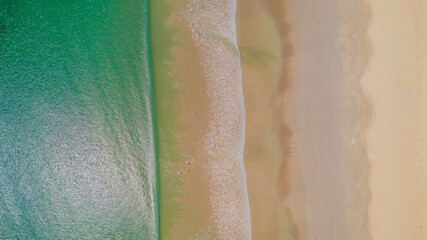 Aerial view of waves rolling onto a beach at Cape Northumberland, South Australia, with textured ocean patterns and foamy lines meeting the shoreline, capturing the raw, windswept beauty of Australia’ © Niki