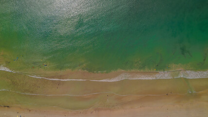 Aerial view of waves rolling onto a beach at Cape Northumberland, South Australia, with textured ocean patterns and foamy lines meeting the shoreline, capturing the raw, windswept beauty of Australia’ © Niki
