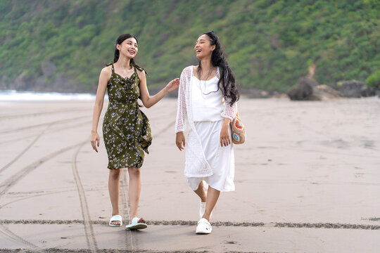 Indonesian Friends Walking Together on Parangtritis Beach