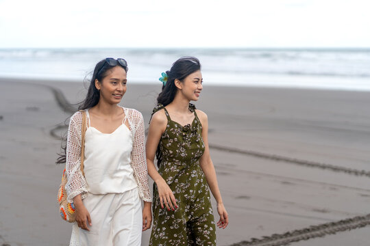Friends Enjoying Morning Walk on Parangtritis Beach Yogyakarta