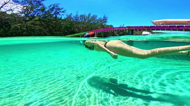 Woman snorkeling underwater in turquoise caribbean sea