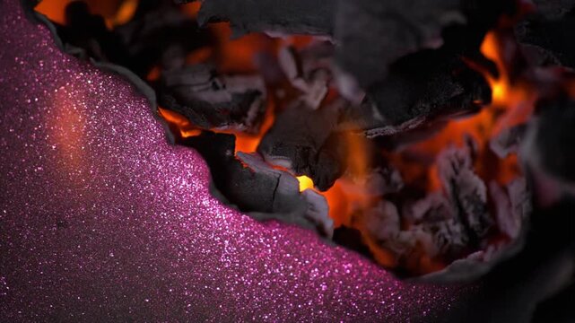 Macro Burning Purple Glitter Paper with Glowing Hot Embers Background