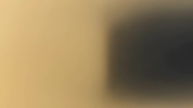 Blurred warm light transition into dark shadow background