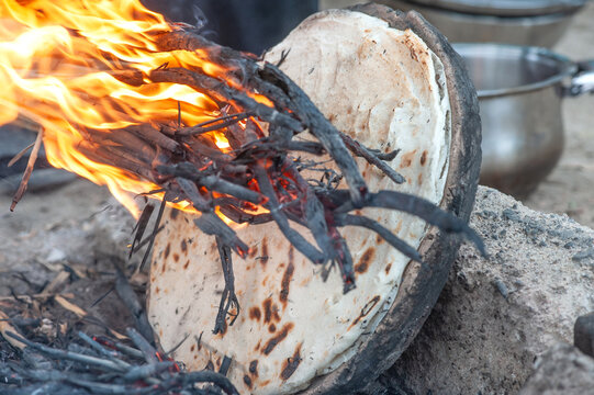 The traditional practice of making rice bread using an open fire in a local village in 
the Southern Marshes of Iraq, home to the Marsh Arabs also known as The Ma&rsquo;dan, Middle East.
