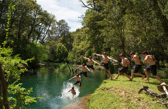 Multiple exposure of a teenage boy leaping into a river