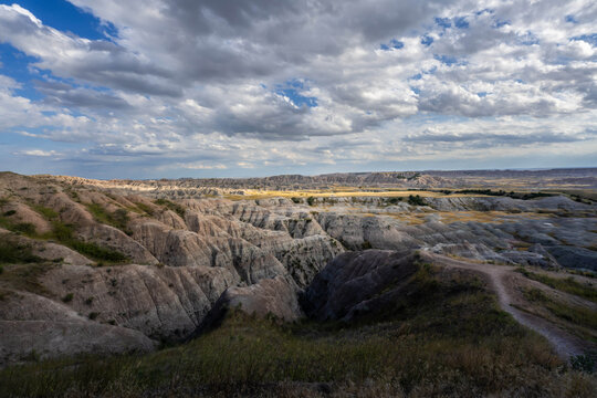 Badlands Canyon Landscape Under Dramatic Cloudy Sky in Badlands NP