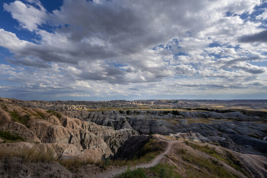Badlands Canyon Landscape Under Dramatic Cloudy Sky in Badlands NP