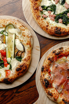 Prepared craft pizzas with various toppings in an authentic pizzeria.