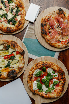 Set of several craft pizzas with magazines with space for text