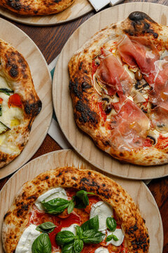 Set of several craft pizzas with magazines with space for text