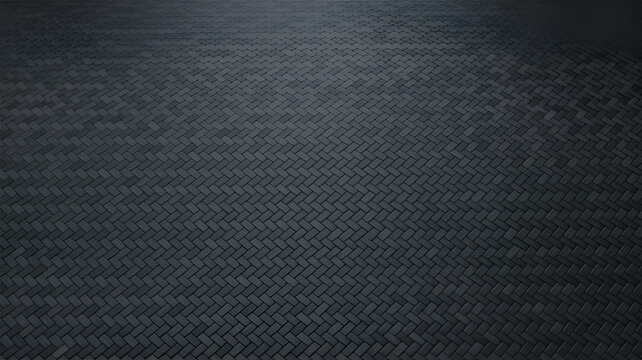 A dark, textured surface featuring a repeating herringbone pattern made of rectangular bricks or tiles, captured from a high-angle perspective