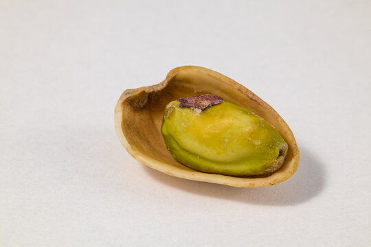 Pistachio kernel in empty pistachio shell isolated on white background