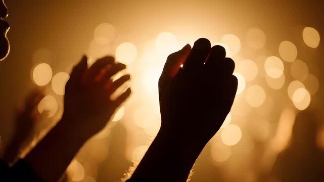 Suitable for religious, concert, worship, or celebration themes. Hands raised in awe amidst glowing lights and blurred silhouettes.